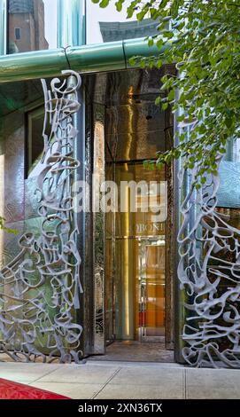 40 Bond Street, a modern condo incorporated in the NoHo Historic District Extension. An aluminum sculpture screens the blue-green glass façade. Stock Photo