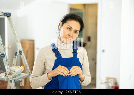 Sad woman builder standing in construction site Stock Photo