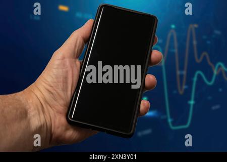 Mans hand holding black screen mobile phone Stock Photo - Alamy