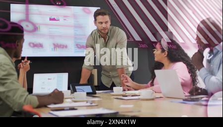 Business meeting with data analytics image over diverse team discussing reports Stock Photo