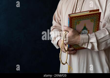 Muslim man is reading the quran. Muslim man praying in mosque for blessings in a sunlit old Islamic of mosque. Stock Photo