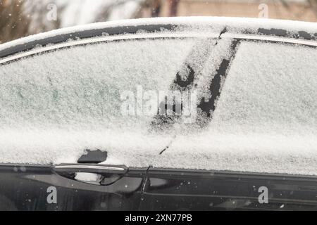 Frost covering a car's window and body in Alberta, Canada during winter Stock Photo