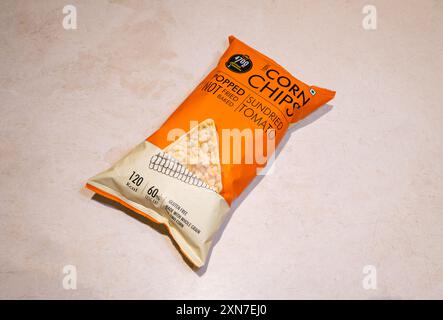 A packet of PVR 4700BC Corn Chips+ Sun Dried Tomato on marble background. Stock Photo