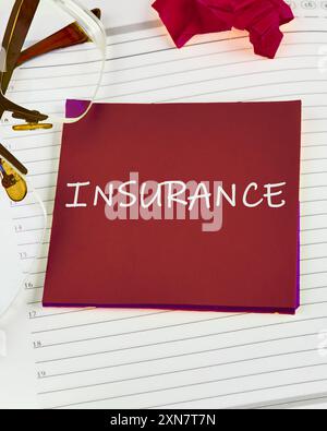 Health, car, real estate insurance business concept. INSURANCE message word on a red sticker on the background of a sheet in a ruler Stock Photo