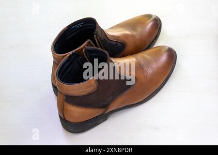 Brown color leather mens shoes on white background. Stock Photo