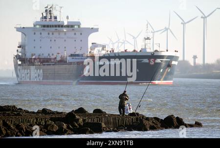 Fisherman at Europoort.Port of Rotterdam.Holland.Hoek van Holland.River The Nieuwe Waterweg.Container ship.Stena Weco Stock Photo