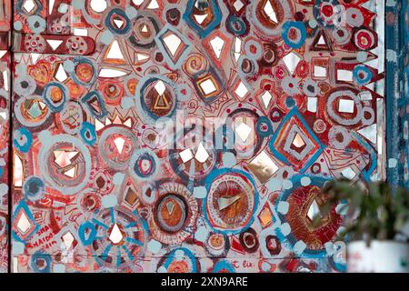 Riga, Latvia - September 30, 2020: Colorful abstract mural adorned with geometric patterns and mirrors in a lively space. Stock Photo