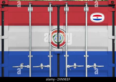 Paraguay flag depicted on metal doors of shipping cargo container outdoors in docks area close up Stock Photo