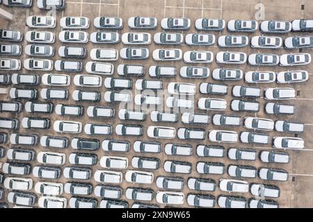 (240731) -- CHONGQING, July 31, 2024 (Xinhua) -- An aerial drone photo taken on July 30, 2024 shows vehicles to be exported at the Chongqing Railway Port of Chongqing International Logistics Hub Park in Shapingba District of Chongqing, southwest China. Chongqing International Logistics Hub Park, along with its 62 freight train routes, has risen to be a major hub of international freight trains in the country's western region. As many international logistics channels converge in Chongqing, the mountainous city is leveraging its connectivity, playing a strategic fulcrum role and transforming Stock Photo