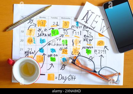 Calendar with business appointments for the new year 2024,pen,coffee cup and spectacles, monthly schedule with days off for better life work balance.B Stock Photo