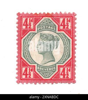 A vintage Queen Victoria four and a half pence postage stamp from Great Britain on a white background. Stock Photo