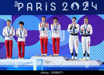 Gold Medalists Chen Yuxi and Quan Hongchan of China (centre), Silver Medalists Jo Jin Mi and Kim Mi Rae of South Korea (left) and Bronze Medalists Andrea Spendolini-Sirieix and Lois Toulson Great Britain following the Women's Synchronised 10m Platform Final at the Aquatics Centre on the fifth day of the 2024 Paris Olympic Games in France. Picture date: Wednesday July 31, 2024. Stock Photo