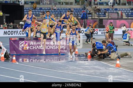 Crossing the barrier with water during the men's 3000m steeplechase ...