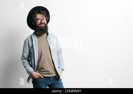Stylish bearded man smiling in studio portrait Stock Photo