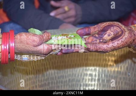 Wedding Couple Nice Hands, hindu groom and bride's hands during marriage ceremony, water eclipse ceremony Stock Photo