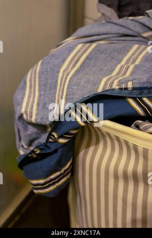 Basket with dirty bed linen before future washing Stock Photo