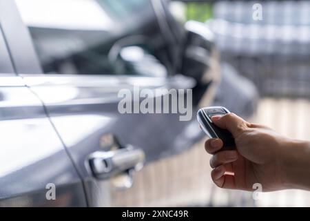 Hand unlocking car with car key Stock Photo