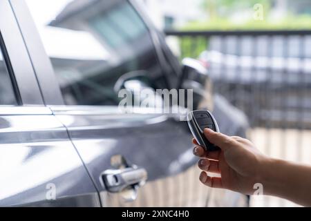 Hand unlocking car with car key Stock Photo