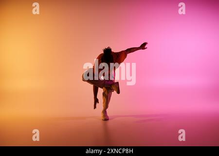young african american hip hop dancer in motion on gradient background Stock Photo