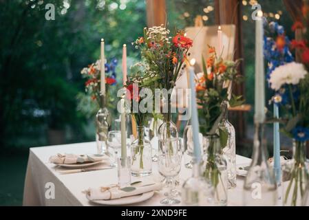 Decorated atmospheric table for a conservatory wedding. The concept of serving and decorating the holiday Stock Photo