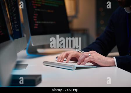 Side view closeup of male hands typing on PC keyboard with unrecognizable computer programmer working copy space Stock Photo