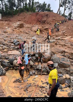 (240731) -- KERALA, July 31, 2024 (Xinhua) -- Rescuers evacuate people after multiple landslides triggered by heavy rains in Kerala state, India, July 31, 2024. On Tuesday multiple landslides hit Kerala state's Wayanad district causing severe losses of life and property. So far 165 people have been declared dead in the landslides. Officials said the death toll is likely to rise as over 100 people are still missing and several more bodies are reported to be lying buried beneath the debris. (UNI/Handout via Xinhua) Stock Photo