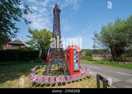 July 31st 2024. A red phone box decorated to celebrate the Paris Olympics. The Olympic Games celebrations include a large model of the Eiffel Tower next to the traditional red phonebox with a Team GB medals table that is being updated daily. Stock Photo