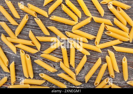 pasta penne rigate on wood background top view Stock Photo