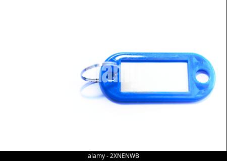 Keychain Plastic key holder in different colors with white background and various papers and a keyboard in the concept of organization and order in co Stock Photo