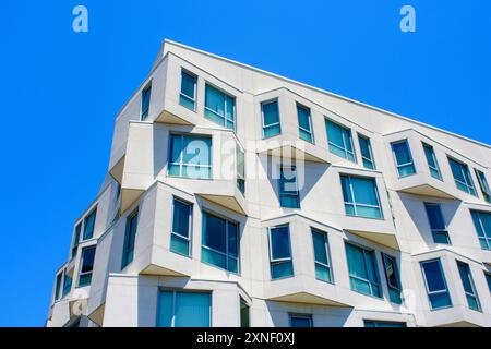 Modern angular building against blue sky Stock Photo - Alamy