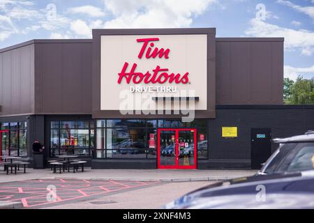 WATFORD, UK - July 10, 2024. Exterior of Tim Hortons Drive Thru coffeehouse and restaurant in London, England Stock Photo