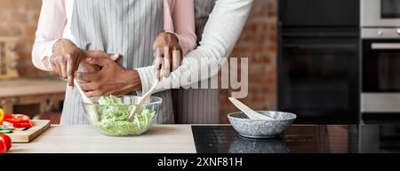 Cropped image of married couple cooking together at kitchen Stock Photo
