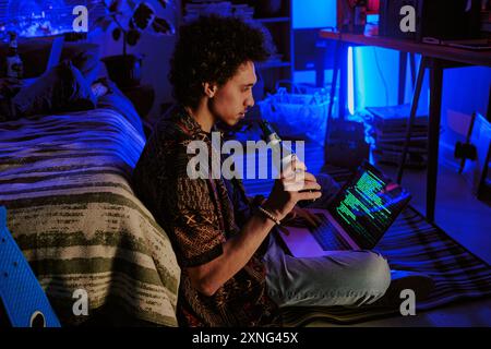 Young Programmer taking beer sip while writing codes for future startup Stock Photo