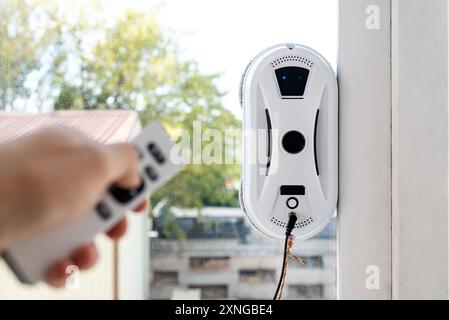 Remote control of a robotic window washer that washes glass from dirt and stains Stock Photo