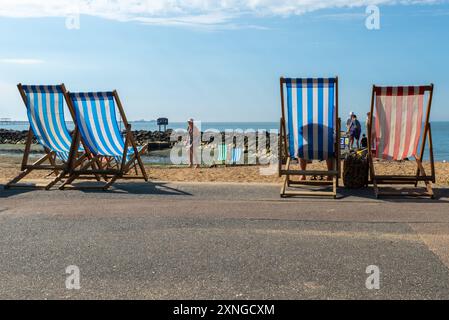 Classic deckchairs overlooking Three Shells Lagoon, Southend on Sea seafront, Western Esplanade, Essex, UK. Lagoon criticised for stagnant water Stock Photo