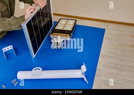 Bracket holder for mounting solar panel and LED lamp as cordless, autonomous street lighting. Stock Photo