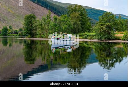Invergarry, Highlands, Scotland, UK. 31st July, 2024. A flowery boat on a fine day at Loch Oich in the Highlands of Scotland in the Great Glen near Invergarry. Credit: John Eveson/Alamy Live News Stock Photo