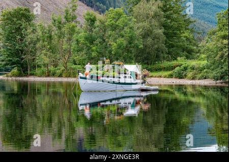 Invergarry, Highlands, Scotland, UK. 31st July, 2024. A flowery boat on a fine day at Loch Oich in the Highlands of Scotland in the Great Glen near Invergarry. Credit: John Eveson/Alamy Live News Stock Photo