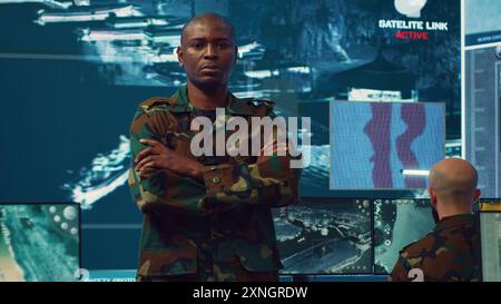 African American commander in camouflage speaking and pointing at ...