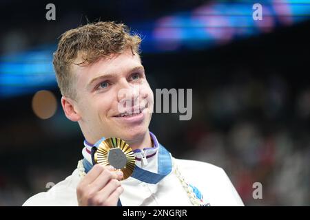 Paris, France. 31st July, 2024. Olympics, Paris 2024, 200 m breaststroke, men, final, winner Leon Marchand from France celebrates with his gold medal. Credit: Michael Kappeler/dpa/Alamy Live News Stock Photo