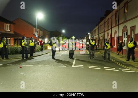 Police officers on the streets of Hartlepool following a violent protest. Videos on social media show a crowd of people in a street, with one showing a youth throwing objects at a line of police in riot gear holding shields. It comes after similar disorder in Merseyside and Whitehall, London after the mass stabbing in Southport that claimed the lives of three girls and left eight more children and two adults injured. Picture date: Wednesday July 31, 2024. Stock Photo