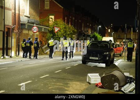 Police officers on the streets of Hartlepool following a violent protest. Videos on social media show a crowd of people in a street, with one showing a youth throwing objects at a line of police in riot gear holding shields. It comes after similar disorder in Merseyside and Whitehall, London after the mass stabbing in Southport that claimed the lives of three girls and left eight more children and two adults injured. Picture date: Wednesday July 31, 2024. Stock Photo