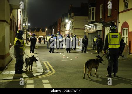 Police officers on the streets of Hartlepool following a violent protest. Videos on social media show a crowd of people in a street, with one showing a youth throwing objects at a line of police in riot gear holding shields. It comes after similar disorder in Merseyside and Whitehall, London after the mass stabbing in Southport that claimed the lives of three girls and left eight more children and two adults injured. Picture date: Wednesday July 31, 2024. Stock Photo