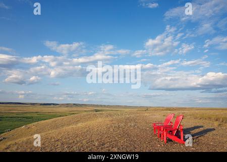 Two red chairs overlooking the Frenchman River Valley in Grasslands National Park, Saskatchewan, Canada Stock Photo