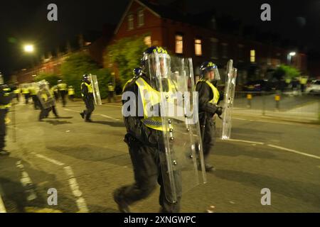 Police officers on the streets of Hartlepool following a violent protest. Videos on social media show a crowd of people in a street, with one showing a youth throwing objects at a line of police in riot gear holding shields. It comes after similar disorder in Merseyside and Whitehall, London after the mass stabbing in Southport that claimed the lives of three girls and left eight more children and two adults injured. Picture date: Wednesday July 31, 2024. Stock Photo