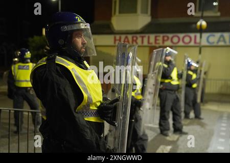 Police officers on the streets of Hartlepool following a violent protest. Videos on social media show a crowd of people in a street, with one showing a youth throwing objects at a line of police in riot gear holding shields. It comes after similar disorder in Merseyside and Whitehall, London after the mass stabbing in Southport that claimed the lives of three girls and left eight more children and two adults injured. Picture date: Wednesday July 31, 2024. Stock Photo