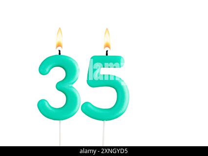 Green birthday candle on white background - Candle number 35 Stock Photo