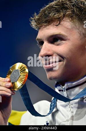 Paris, France. 31st July, 2024. Gold medalist Leon Marchand of France shows the medal during the victory ceremony for the men's 200m breaststroke of swimming at Paris 2024 Olympic Games in Paris, France, on July 31, 2024. Credit: Wang Peng/Xinhua/Alamy Live News Stock Photo