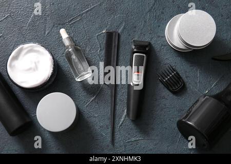 Modern trimmer and shaving accessories on black grunge background Stock Photo