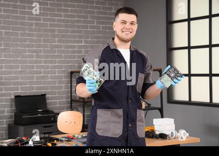Male technician with PC boards in service center Stock Photo
